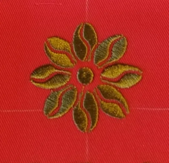 A flower embroidered in thread, close up