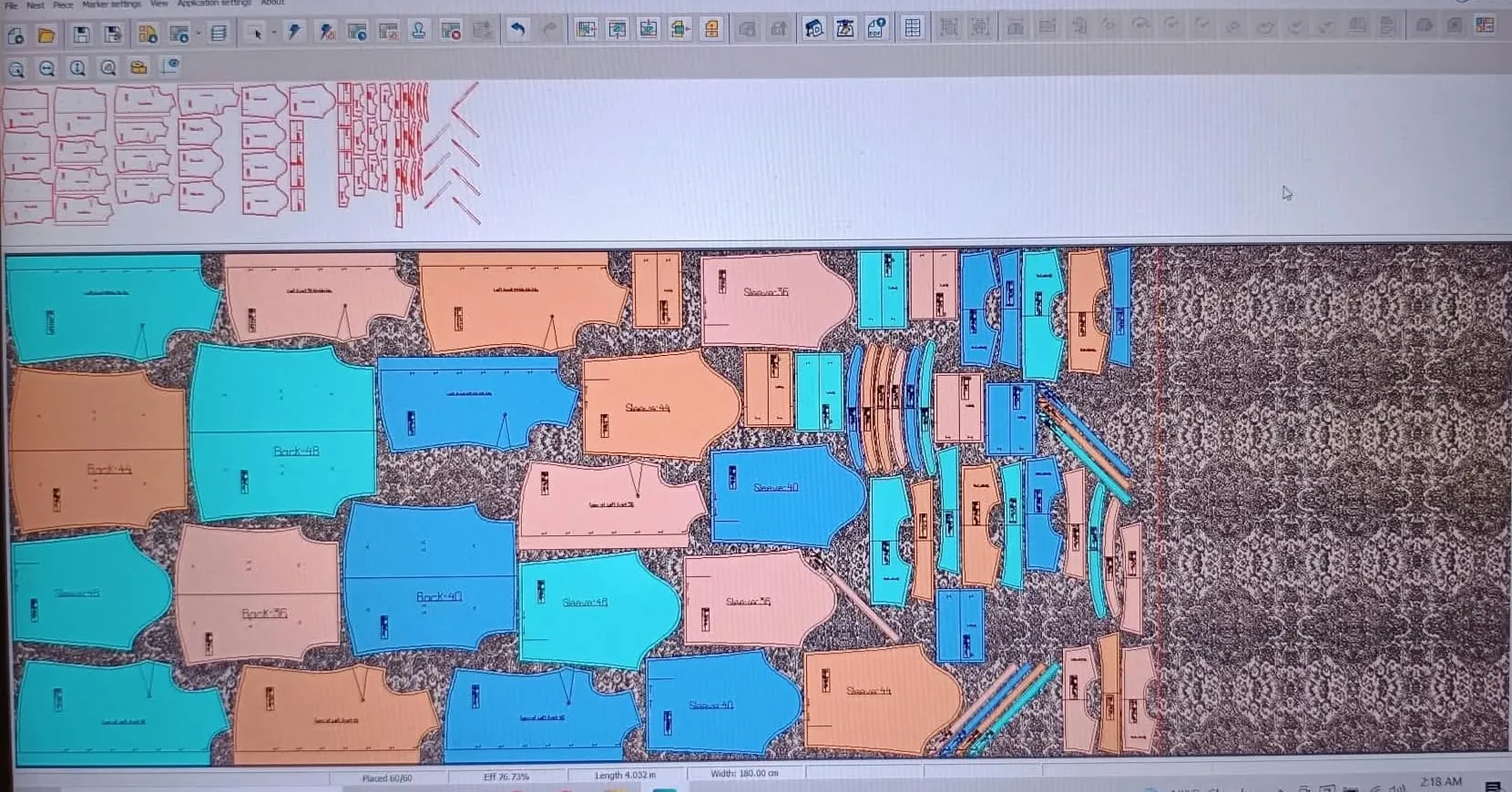 A marker with pattern pieces nested across the fabric width
