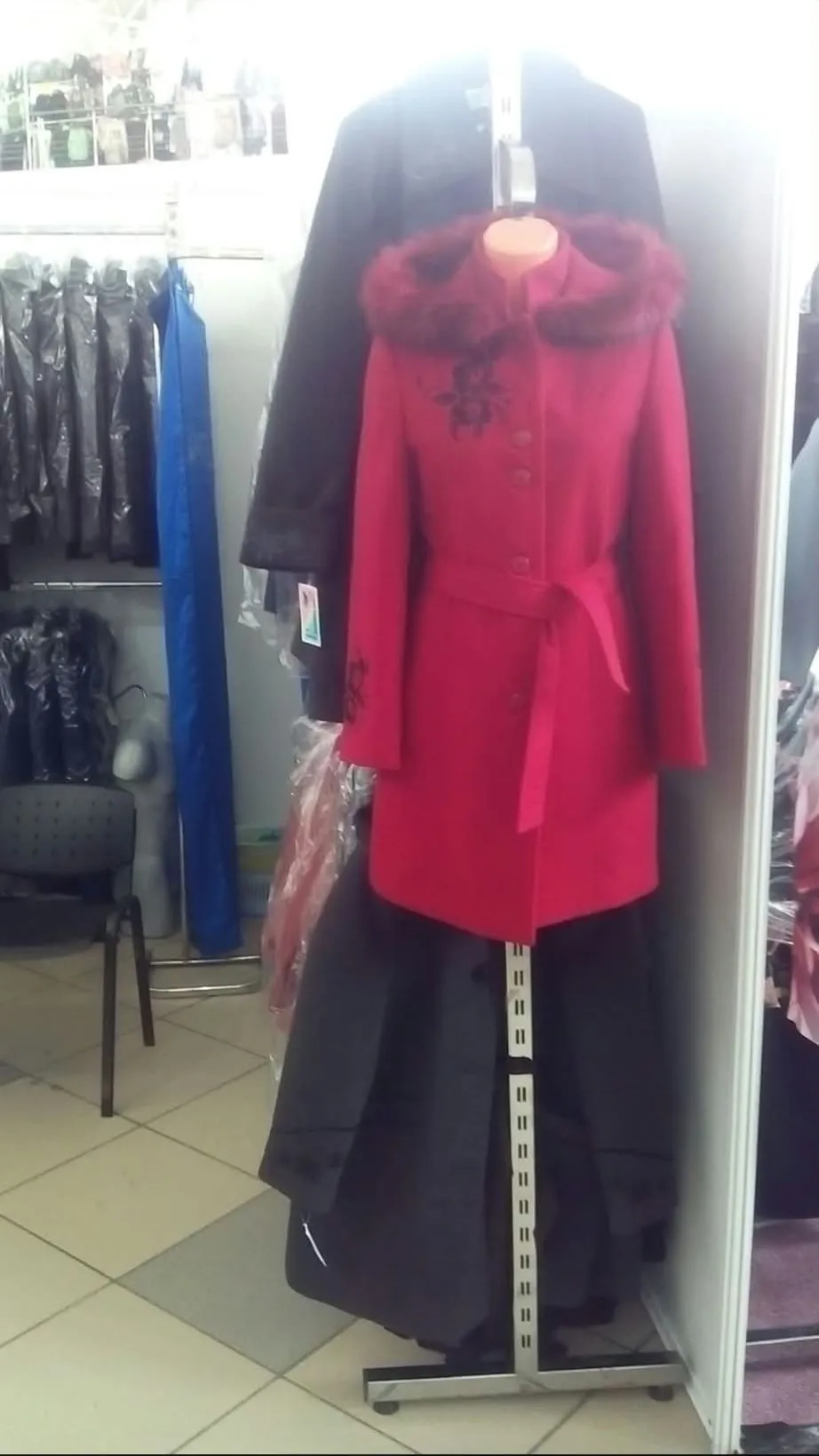 A red coat sample on a mannequin